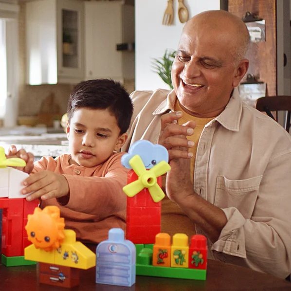 Grandfather and grandson building with MEGA Bloks at home